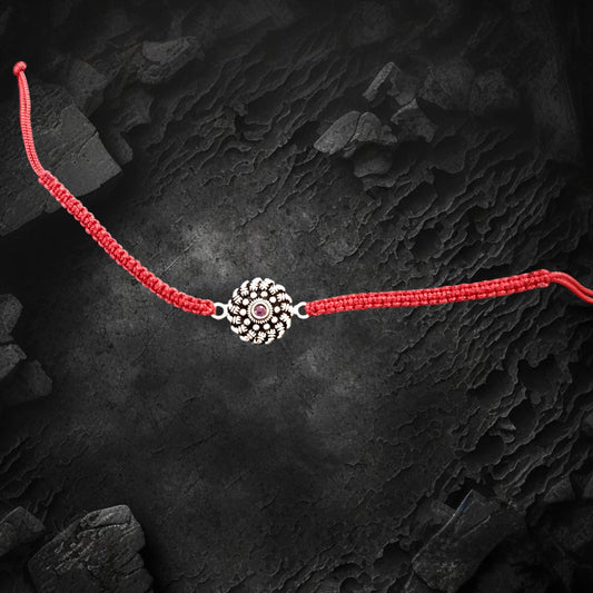 Red stone studded flower silver rakhi bracelet